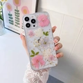 Detail of clear phone case with real pink pressed flowers and gold foil flakes - Gold Foil Resin - Pink Larkspur / 17 Pro Max