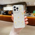 Detailed close-up of real dried flowers and glitter embedded in a clear iPhone case - Starry Resin Pressed Flower - Yellow / iPhone 17 Pro Max