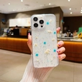 Close-up of clear iPhone case with real dried flowers and glitter in a hand model - Starry Resin Pressed Flower - Blue / iPhone 17 Pro Max