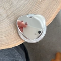 Detailed view of a silver heart-shaped mirror Magsafe phone grip on a wooden surface - Mirror Magnetic - Heart - Silver