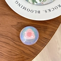 Close-up of holographic resin phone grip with 3D pink handbag decor on wooden desk - Dreamy Bubble No. 34