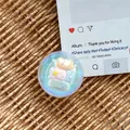 Detail of glitter heart phone socket with cute cartoon bear on a woven mat background - Dreamy Bubble No. 109