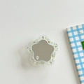 Close-up of star-shaped glitter phone grip featuring a mirror surface and mine. text - Transparent Glitter Flower Mirror - Yellow
