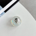 Detailed close-up of iridescent resin phone grip featuring a silver strawberry relief - Crystal Ball Grip - Dreamy Bubble - No. 70