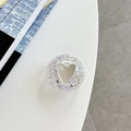 Detail of glitter heart mirror phone grip with mi ne text on a white minimalist desk - Adhesive Sequin Heart Mirror - Glitter Purple
