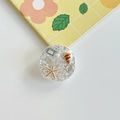 Detail of round ocean-style phone grip with silver glitter and embedded starfish shell motifs - Epoxy Stand - High Glitter Ocean - Silver