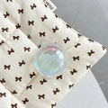 Close-up of iridescent crystal ball phone grip with 3D white bow on quilted fabric - Crystal Ball Holder-Dreamy Bubble-No.60 Matte Blue Bow