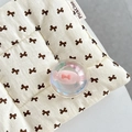 Close-up of a clear crystal ball with a pink bow candy charm on a knit cushion - Crystal Ball Holder-Dreamy Bubble-No.62