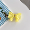 Detail of yellow translucent bow phone grip with heart-shaped gold-rimmed center ornament - Large Bowknot French Heart Yellow