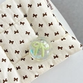 Close-up of a transparent resin ball phone grip with a green bow inside on a soft mat - Crystal Ball Holder-Dreamy Bubble-No.66