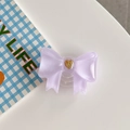 Macro detail of purple bow phone grip with golden heart on a minimalist white desk - Large Bowknot French Heart Purple