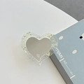 Détail du support MagSafe en forme de cœur à paillettes avec logo mine. sur un carnet bleu - Support Transparent Miroir de Coeur à Paillettes (Jaune)