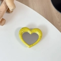 Detailed view of heart-shaped phone grip with yellow speckled finish and built-in mirror - Dark Yellow (Splatter Heart Mirror)