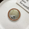 Detailed close-up of a circular MagSafe vanity mirror with brown and clear double-layer frame - Brown