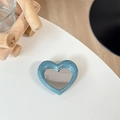 Macro shot of blue speckled heart mirror phone socket on a minimalist desk setup - Ink Blue (Splatter Heart Mirror)