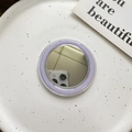 Detail view of a round MagSafe makeup mirror with a purple frame and high-reflective surface - Purple