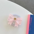 Dettaglio del supporto per telefono a fiocco in resina rosa con cuore dorato - Grande Fiocco Magnetico Cuore Francese / Rosa