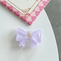 Detailed view of light purple resin bow phone grip with a delicate gold metal accent - Purple