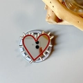 Detail of heart mirror phone grip with red trim and silver spikes on folding base - Magnetic Hedgehog Heart Mirror / Brown