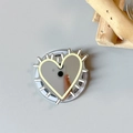Macro view of silver heart-shaped phone grip with metallic mirror finish and jagged edges - Magnetic Hedgehog Heart Mirror / Yellow