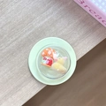 Macro view of phone grip featuring a cute miniature duck and mushroom house landscape - Magnetic Film Duck House Ball Yellow