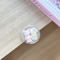 Detail shot of a clear round phone grip with 3D miniature bear and blue house models - Transparent Stand Ball House Pink Bear