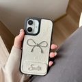 Detail of cream leather iPhone case with silver bow and rhinestone Smile ornament - Pearl Mirror Stand Bowknot (17Promax) / White