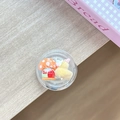 Detail of a cute mushroom house and duck 3D resin piece inside a round phone stand - Transparent Stand Ball House Duck