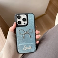 Detail of light blue leather iPhone case with silver bow and rhinestone Smile design - Pearl Mirror Stand Bowknot (17Promax) / Blue