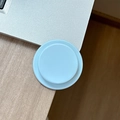 Macro detail of foldable light blue and white magnetic phone socket on a wooden desk - Mint Green
