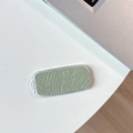 Detail of the green shimmer eyeshadow with snake pattern texture and clear flip cover lid - Pearlescent Texture / Green