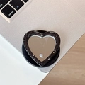 Dettaglio macro del supporto telefono a cuore con specchio glitterato e testo mine - Nero
