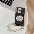 Macro view of iPhone case featuring pearl chain strap and crown mirror decoration - Black / iPhone XR