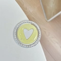 Close-up of glittery heart phone grip with sparkling rhinestones and yellow finish - Yellow