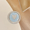 Detailed view of rhinestone magnetic phone grip with glitter and silver heart motif - Blue