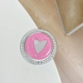 Detailed close-up of a heart-shaped phone grip with rhinestones and pink glitter finish - Deep Pink