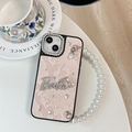 Close-up of pink snake skin texture phone case with rhinestone logo and pearl strap - Large-hole Snakeskin Pattern - Bow Rhinestone Pearl Necklace - Pink / iPhone 17 Pro Max