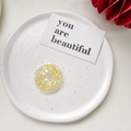 Detail of round shell texture phone grip on a ceramic tray with artistic prop - Shell Pattern Grip - Yellow