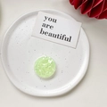 Detailed top view of mint green shell texture phone socket stand on ceramic tray - Shell Pattern Grip - Light Green
