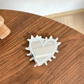 Close-up of heart-shaped phone grip with silver mirror finish on a wood surface - Transparent Stand - Hedgehog Heart Mirror - Blue