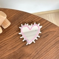 Close-up of heart-shaped phone grip mirror with pink trim on dark wood surface - Transparent Stand - Hedgehog Heart Mirror - Deep Pink