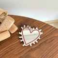Close-up of heart-shaped makeup mirror with red border on a rustic wooden table - Transparent Stand - Hedgehog Heart Mirror - Brown