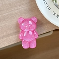 Detailed macro view of a glittery pink bear-shaped phone grip on a white ceramic tray - Standard Pop Socket Style / Pearlescent Bear - Rose Red