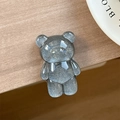 Macro view of silver glitter bear phone socket holder on a natural wooden desk surface - Standard Pop Socket Style / Pearlescent Bear - Silver Gray