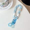 Close-up of a blue woven phone wrist strap with star pendants and handmade tag details - (Smiley Face) Short Rope-Star Pendant-Blue