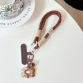 Detail of dark brown braided phone lanyard with bell, metal clasp and flower charms - (Smiley Face) Short Rope-Star Pendant-Brown