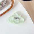 Close-up of a pearlescent light green cloud phone grip with a silver handmade metal tag - Sticky-Silver Cloud-Glitter Light Green