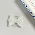 Close-up of glittery white bow phone grip with MagSafe suction on grey background - Pearl Adhesive Style / White