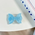 Detail of light blue glitter bow MagSafe phone grip with transparent air cushion base - Pearl Adhesive Style / Blue