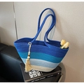 Detail of woven gradient blue straw tote bag with cotton fringe and wood bead charm - Blue